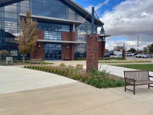 Landscape plantings and bench at a commercial building entrance