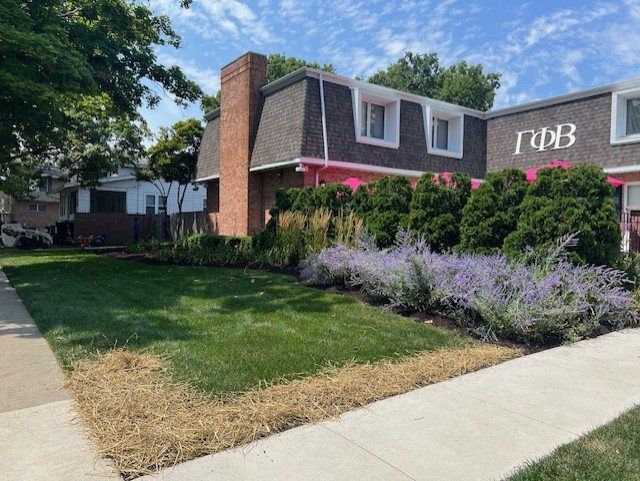 Lavender and shrub beds in front of a brick commercial building