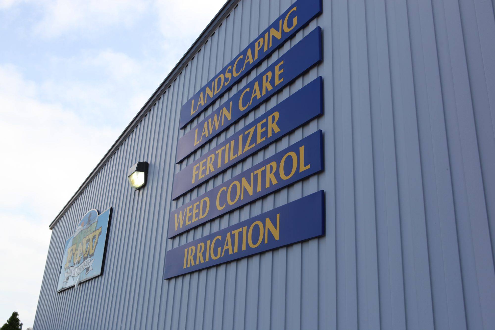 F&W building in Bloomington with signs for landscaping, lawn care, fertilizer, weed control and irrigation