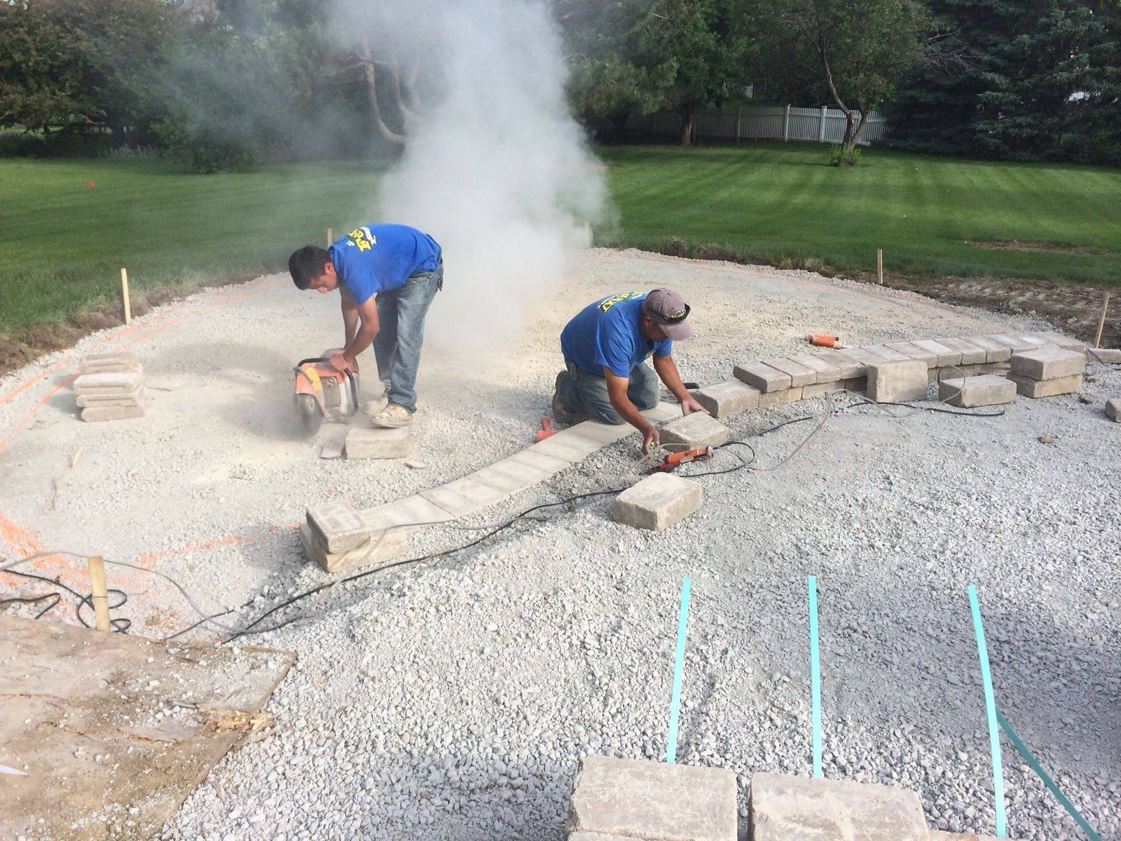 F&W crew cutting and setting pavers on a compacted gravel base