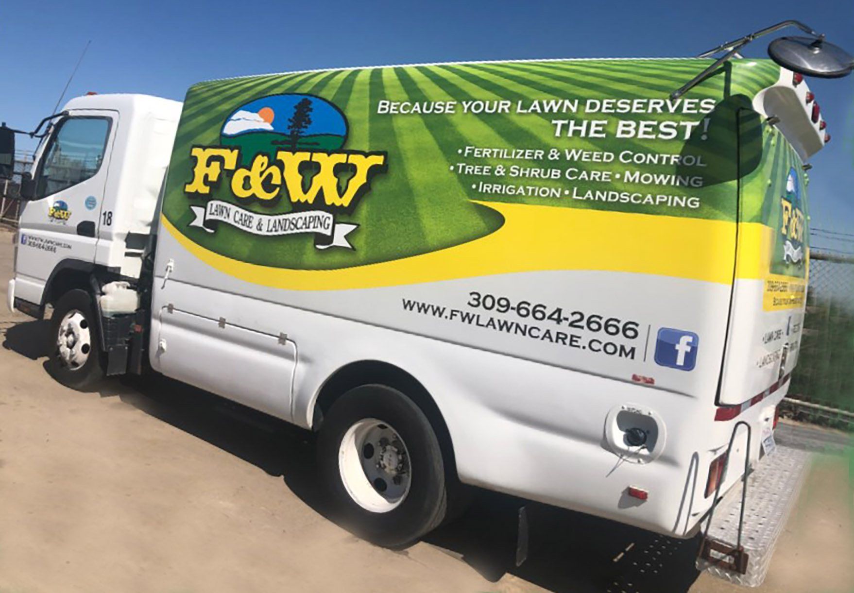 F&W Lawn Care & Landscaping company van with the logo and phone number
