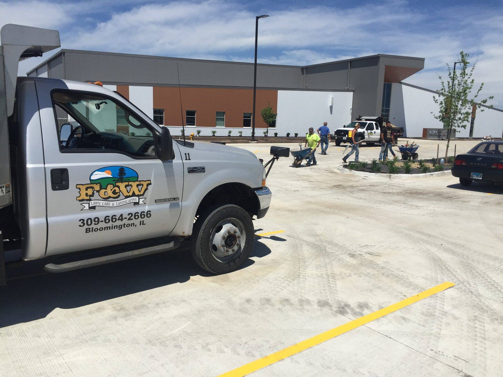 F&W Lawn Care & Landscaping truck on a commercial landscaping job site