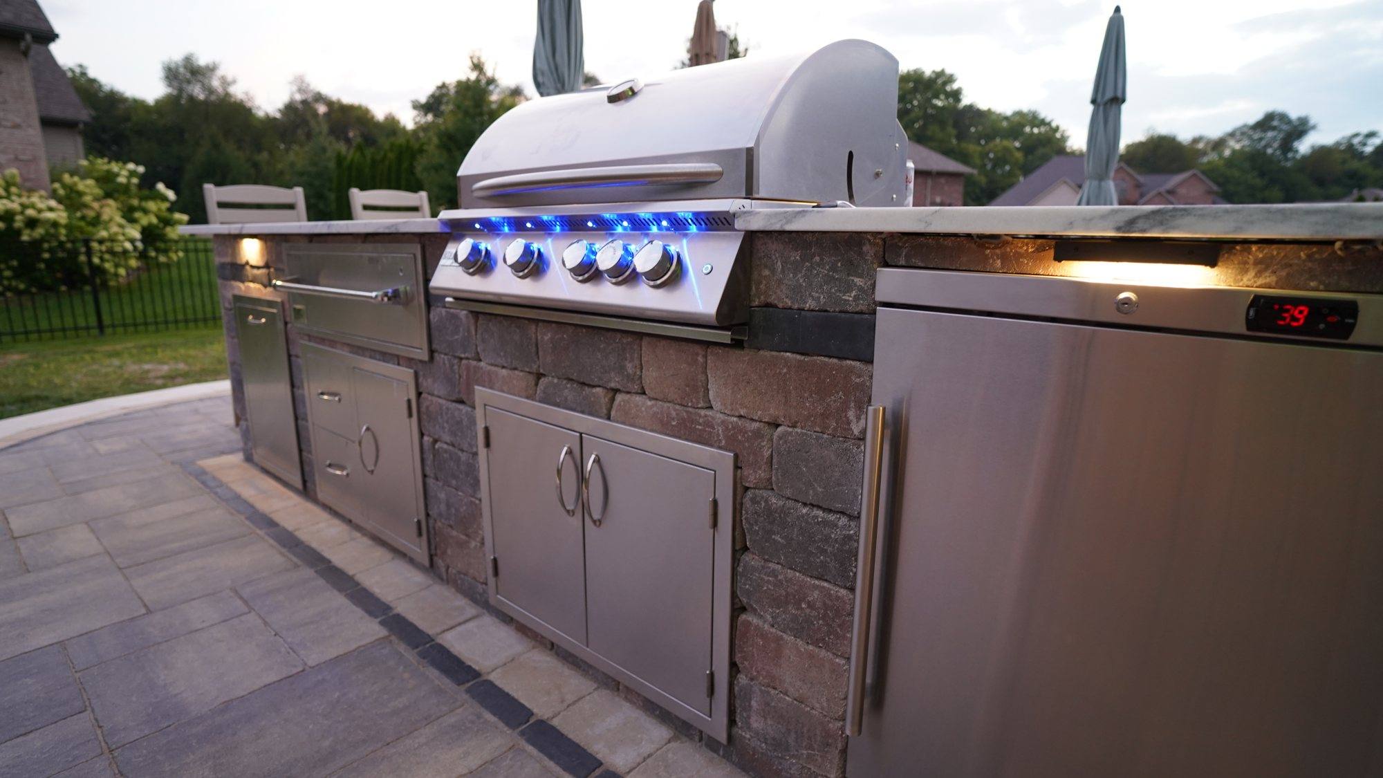 Built-in stainless grill and stone outdoor kitchen on a Bloomington patio