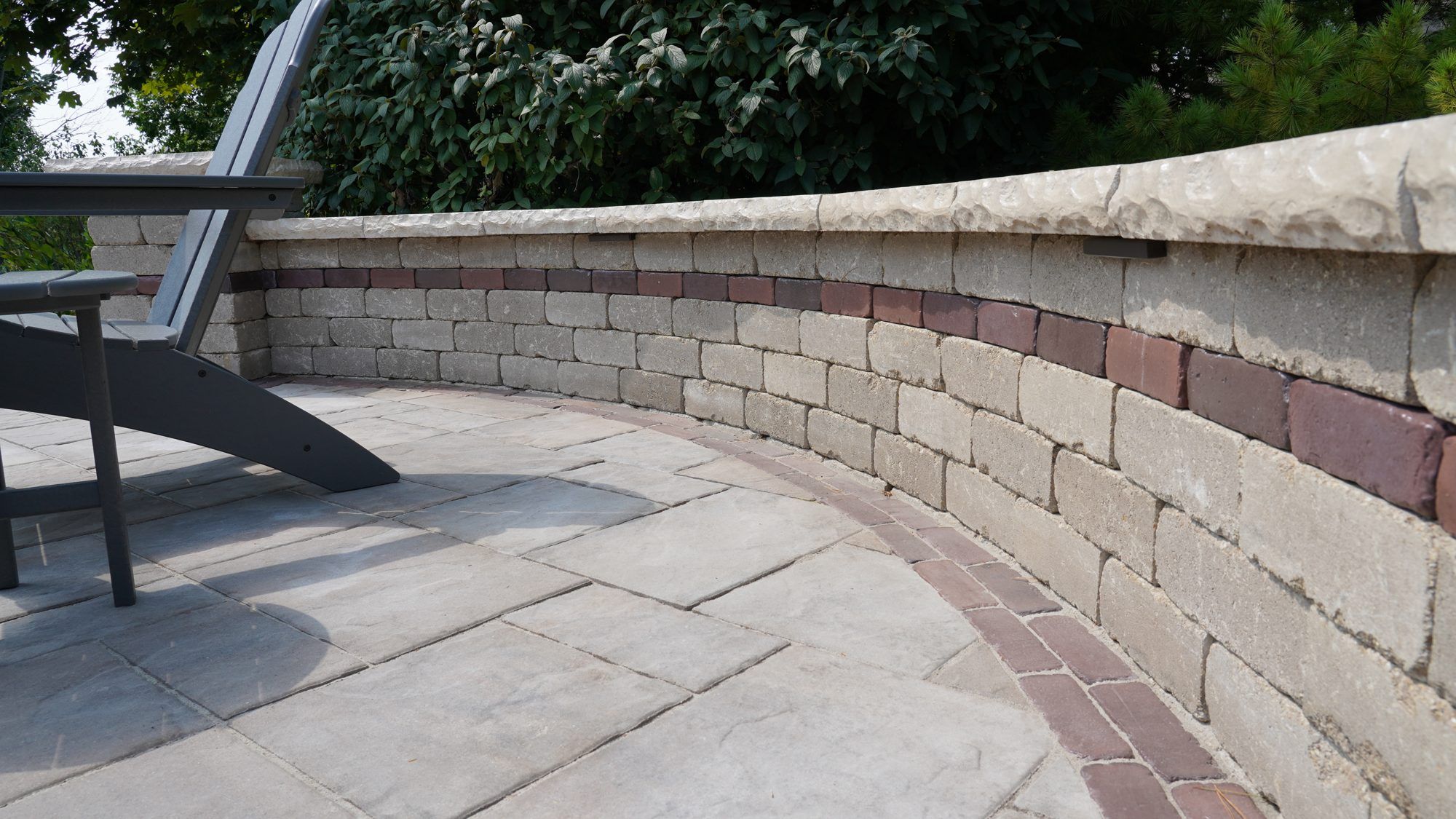 Curved block seat wall with a brick paver border