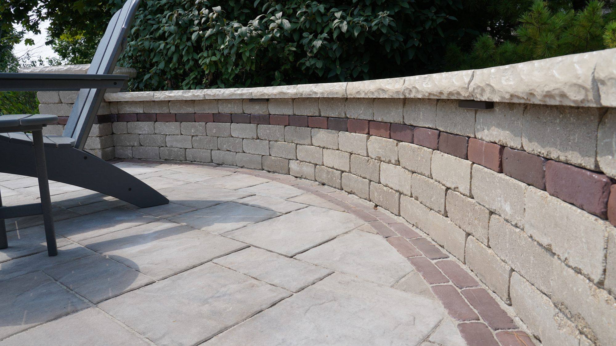 Curved block seat wall with a brick paver border