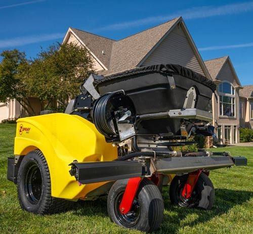 Ride-on spreader-sprayer used for professional lawn fertilization and weed control